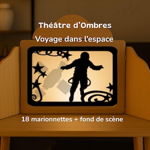 May include: A light wood shadow theater with a backlit screen displaying black silhouettes of an astronaut, a satellite, and stars. The text reads: Théâtre d'Ombres, Voyage dans l'espace, 18 marionnettes + fond de scène. The frame has side panels.