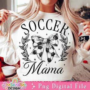 May include: White sweatshirt with black text that reads "Soccer Mama" and a black and white soccer ball bow with leaves and stars.