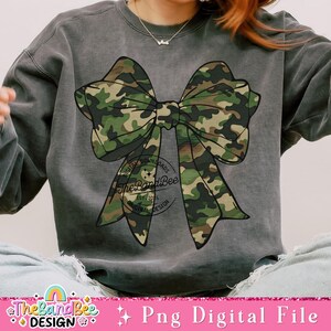May include: A gray sweatshirt with a camouflage bow and a circular logo that says "The Band Bee" with the text "Digital Downloads Est 2014 Original Design".