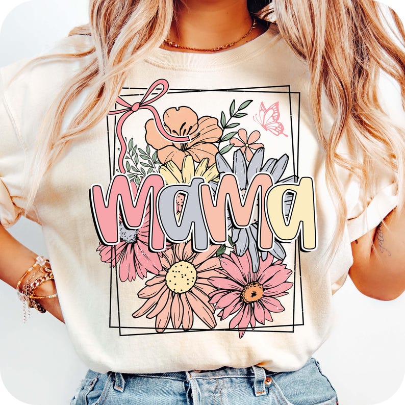 May include: A white t-shirt with a floral design and the word "mama" in pastel colors. The flowers are pink, yellow, and blue.