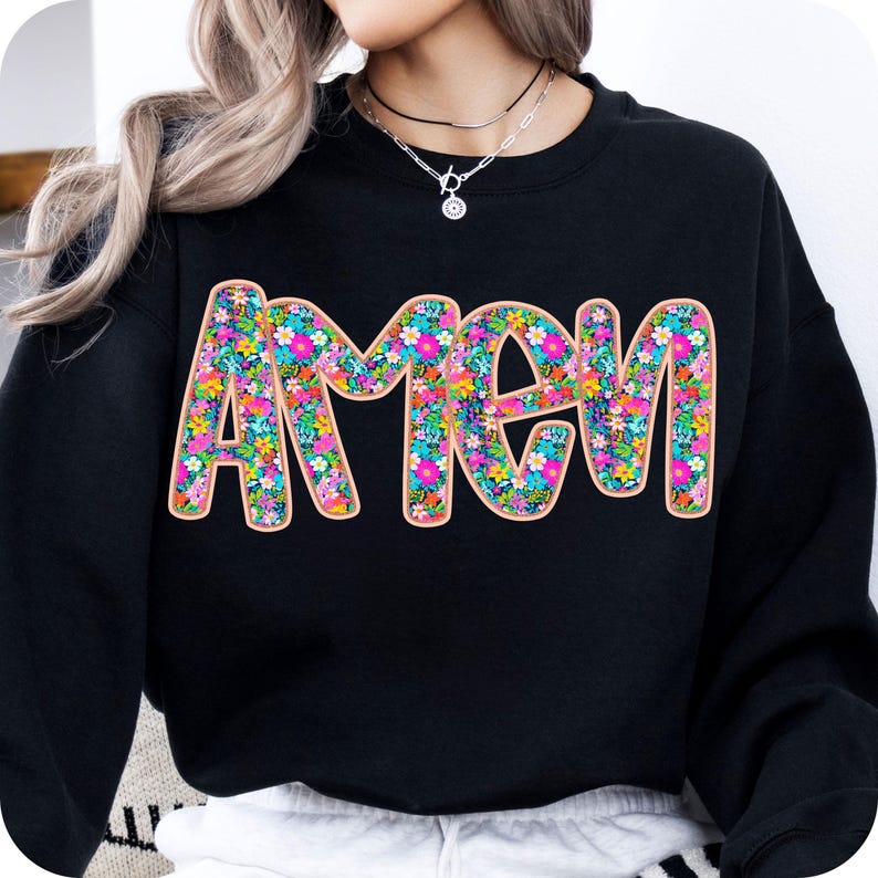 May include: Black sweatshirt with the word "AMEN" in large, colorful letters. The letters are filled with a floral pattern of pink, blue, green, and yellow flowers.