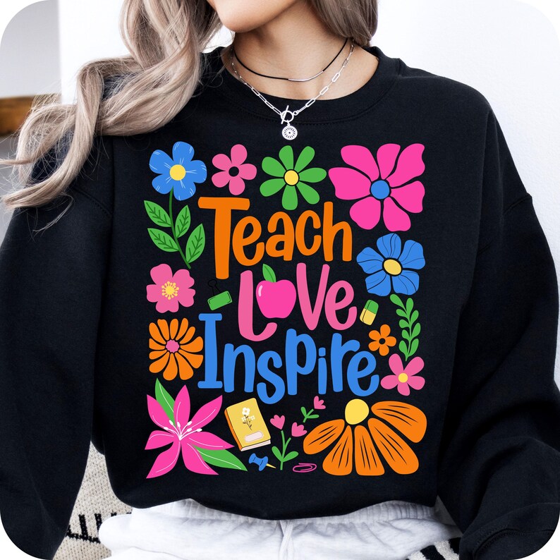 May include: Black sweatshirt with a colorful floral design and the text "Teach Love Inspire".