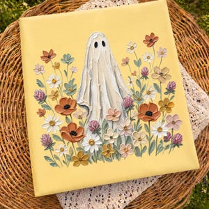 May include: A square canvas painting with a pale yellow background featuring a central white ghost figure surrounded by a dense arrangement of textured, impasto-style flowers in shades of orange, white, pink, and muted green.