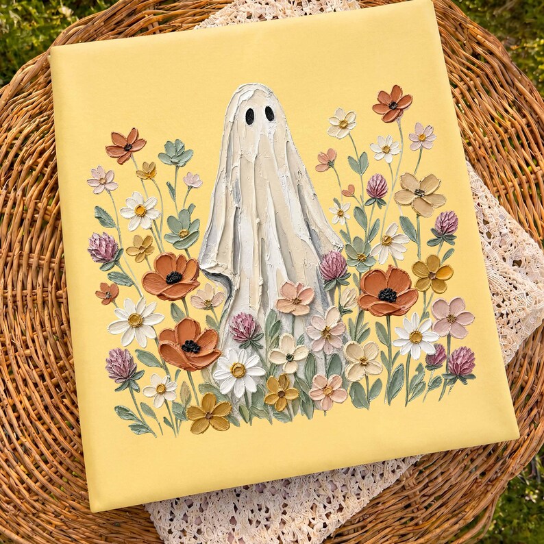 May include: A square canvas painting with a pale yellow background featuring a central white ghost figure surrounded by a dense arrangement of textured, impasto-style flowers in shades of orange, white, pink, and muted green.
