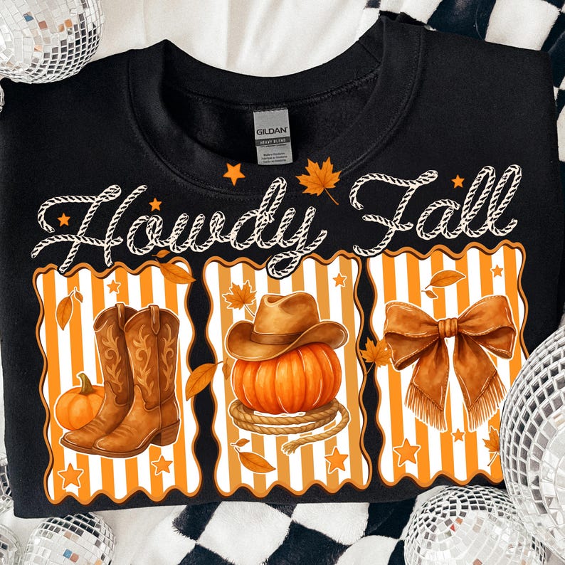 May include: Black sweatshirt with the text "Howdy Fall" in white script. The design includes a pumpkin, cowboy boots, a cowboy hat, and a bow, all in shades of orange and brown. The background features orange and white stripes.