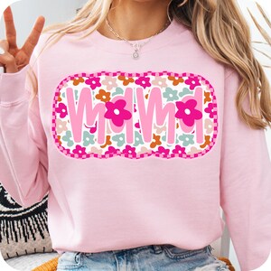 May include: Pink sweatshirt with a floral design and the word "Mama" in a pink, white, and blue font.