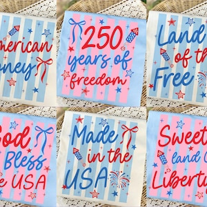 May include: Collection of six light blue t-shirts with patriotic designs. Each shirt features red and blue text, stars, and fireworks. Phrases include "American Honey," "250 years of freedom," and "Land of the Free."