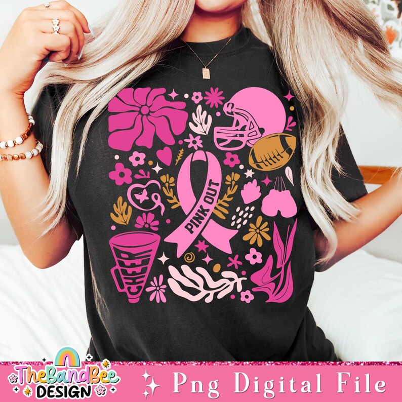 May include: Pink Out design with a pink ribbon, football helmet, football, megaphone, and flowers on a black t-shirt.