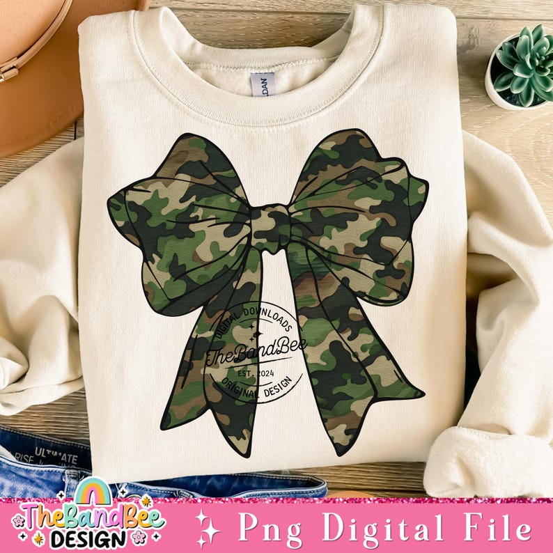 May include: A digital download of a camouflage bow graphic. The bow is green, brown, and black. The graphic is perfect for creating t-shirts, mugs, tote bags, and other crafts.