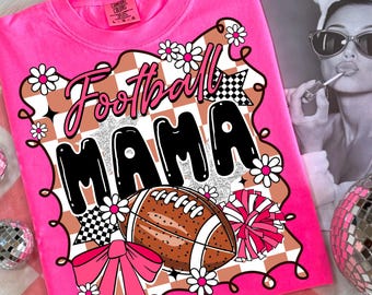 May include: Vibrant pink t-shirt featuring the text "Football Mama" in a black, white, and brown design. The design includes a football, flowers, and a bow. The shirt is a Comfort Colors brand.
