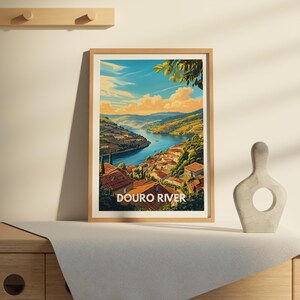 A unique river poster of the Douro is prominently displayed in a modern hallway, complemented by stylish lighting and a console table. The artwork captures the river's peaceful flow, making it a standout piece in the home.