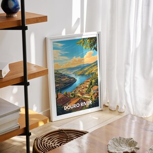 In a minimalist bedroom, a Douro River art print is placed above the bed, framed in a sleek design. The vibrant colors and detailed illustration bring the beauty and calmness of the Douro into the serene space.