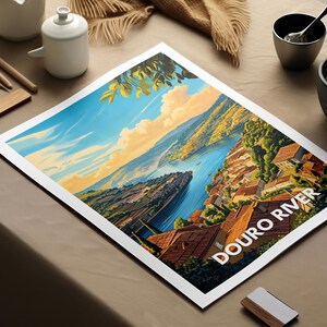 Leaning against a bookshelf in a study, a Europe nature print featuring the Douro River is paired with classic literature and antique decor. The print's depiction of the Douro winding through vineyards adds tranquility to the room.