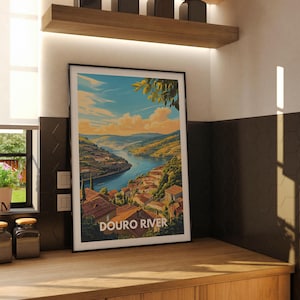 A Europe river art print of the Douro in a dining area creates a focal point above a vintage sideboard. The artwork's intricate details and rich colors evoke the river's majestic flow, enhancing the room's ambiance.
