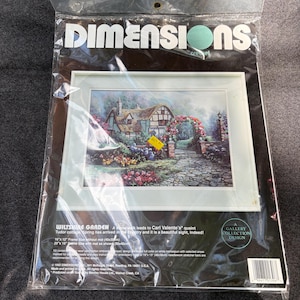 May include: A Dimensions crewel embroidery kit titled Wiltshire Garden featuring a Tudor cottage with a stone path and floral archway. The package includes wool yarn, cotton embroidery thread, and printed homespun fabric for a 16 by 12 inch design.