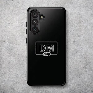 May include: Black phone case with a white graphic that reads "DM ON" inside a rectangular frame. The phone case has a triple-lens camera system and a sleek, glossy finish. The case is designed to protect the phone while adding a touch of style.