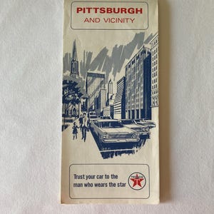 May include: Vintage Pittsburgh and Vicinity brochure. The cover features a blue and white illustration of the city skyline, cars, and people. The brochure includes the text "Trust your car to the man who wears the star" and the Texaco logo.