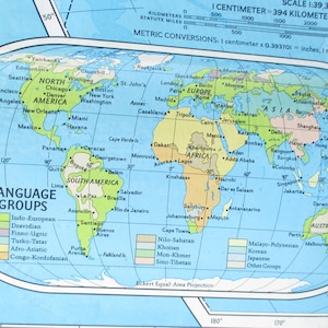 May include: A world map with a blue background and a light blue outline of the continents. The map shows different language groups in different colors: Indo-European, Dravidian, Finno-Ugric, Turko-Tatar, Afro-Asiatic, and Congo-Kordofanian.