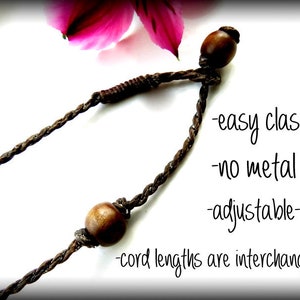 May include: A brown cord necklace with wooden beads and an easy clasp. The necklace is adjustable and the cord lengths are interchangeable. -easy clasp -no metal -adjustable -cord lengths are interchangeable