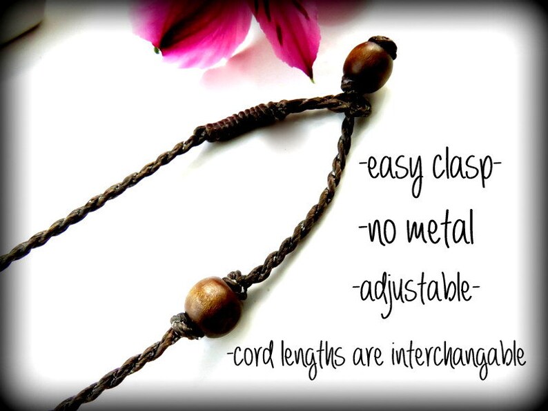 May include: A brown cord necklace with wooden beads and an easy clasp. The necklace is adjustable and the cord lengths are interchangeable. -easy clasp -no metal -adjustable -cord lengths are interchangeable