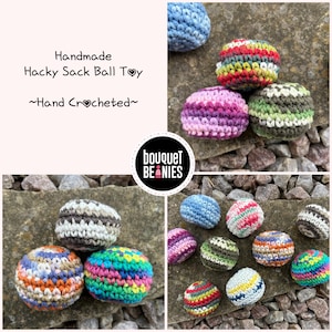 May include: Handmade hacky sack ball toys in various colors, including blue, pink, green, and rainbow hues. The balls are hand-crocheted and feature a striped design. The image includes the text "Handmade Hacky Sack Ball Toy" and "~Hand Crocheted~".