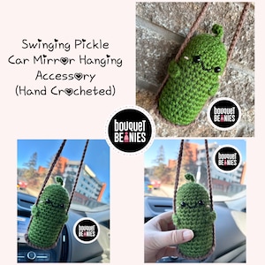 May include: A green crocheted pickle hanging from a brown string. The pickle has a smiling face and is swinging from a car mirror. The text "bouquet beanies" is on a black circle with a pink heart.
