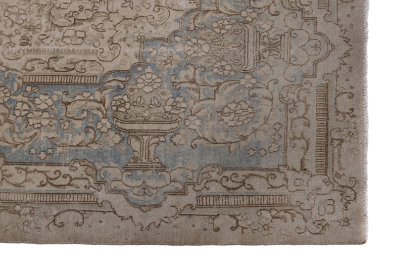 May include: A vintage rug with a light blue and beige color scheme. The rug features a floral pattern with intricate details. The rug has a worn and faded look, giving it a vintage aesthetic.