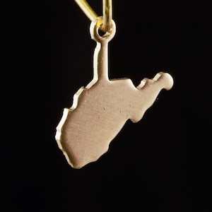 May include: Gold-colored metal charm shaped like the state of West Virginia. The charm is attached to a gold-colored metal loop.