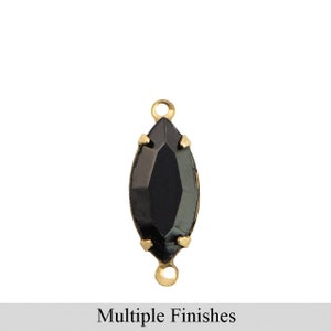 May include: A black marquise-shaped crystal connector with gold-toned metal loops on either side. The connector is a jewelry finding for making necklaces, bracelets, and earrings.