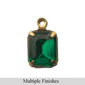 May include: A rectangular emerald green gemstone pendant with a gold-colored metal setting and a loop at the top. The text "Multiple Finishes" is displayed at the bottom of the image.