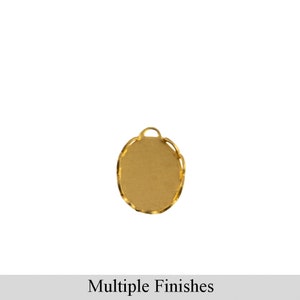 May include: Gold oval-shaped pendant with a smooth surface and a decorative edge. The pendant has a loop at the top for attaching a chain.