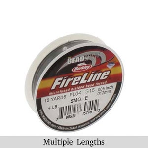 May include: A spool of gray FireLine microfused braided bead thread by Berkley Beadsmith. The label reads "FireLine microfused braided bead thread", "15 YARDS FL04 315 005 inch 012mm", "4 LB SMO E", and "Made in USA of domestic and imported components".