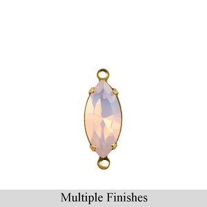 May include: A light pink marquise-shaped crystal with a gold-tone setting and two jump rings. The crystal is faceted and has a pearlescent finish.