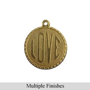May include: Gold-toned metal charm with a circular design featuring the word "LOVE" in a stylized font. The charm has a textured surface and a decorative edge.