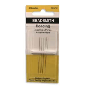 May include: A package of four Beadsmith beading needles, size 13, in a clear plastic container. The package has a yellow and white label with the Beadsmith logo and the words "Beading" and "Finest Quality English Needles."