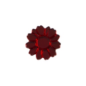 May include: A red glass flower with a raised center and a glossy finish.
