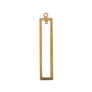 May include: A gold-toned metal pendant with a rectangular frame and a small loop at the top.