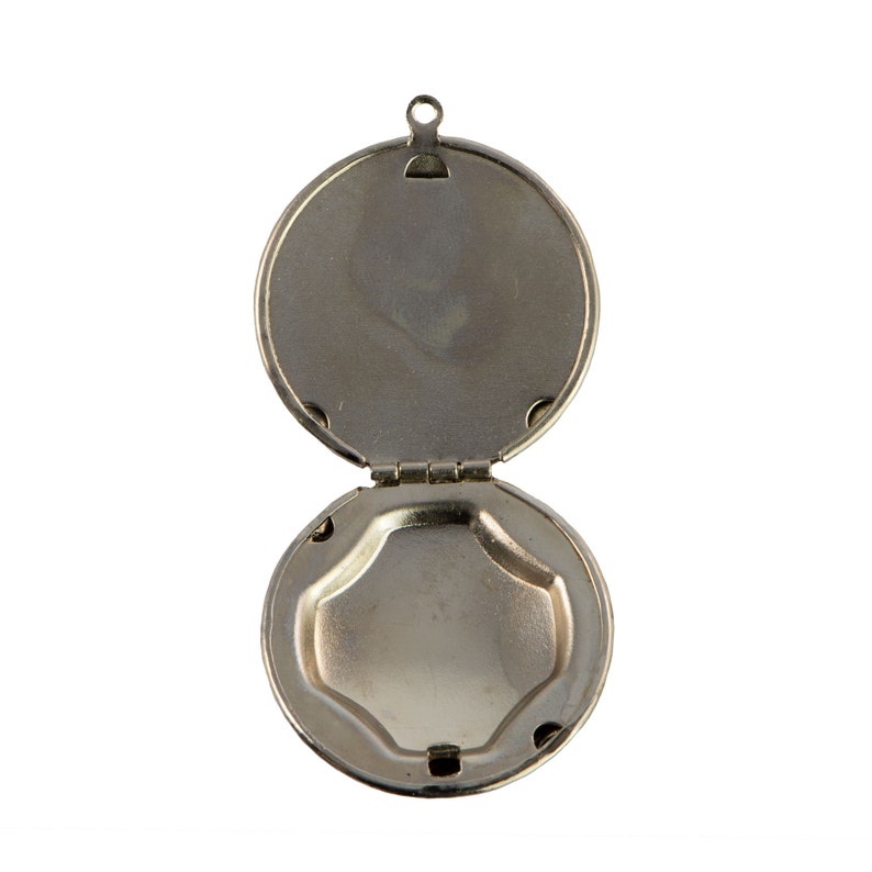 May include: A silver locket with a hinged lid, open to reveal an empty interior. The locket has a simple, round design.