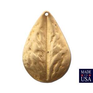 May include: A gold-colored metal leaf pendant with a textured surface. The pendant has a hole at the top for hanging.