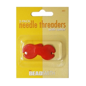 May include: A 2-pack of red needle threaders with cutter, packaged on a yellow and beige card. The text "2-PACK needle threaders with cutter" is printed on the card. The brand name "the BEADSMITH" is also visible.