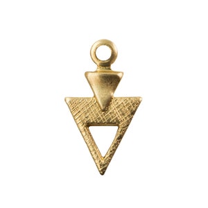 May include: A gold-toned metal pendant shaped like a triangle with a smaller triangle cut out of the center. The pendant has a textured surface and a loop at the top for attaching to a chain.