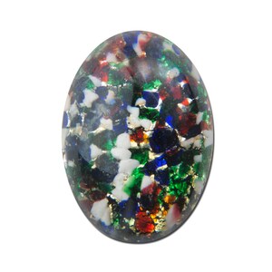 May include: Oval-shaped glass cabochon with a colorful confetti pattern. The cabochon is filled with small pieces of glass in shades of blue, green, red, white, and gold.