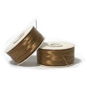 May include: Two spools of gold thread wound on white cardboard spools.