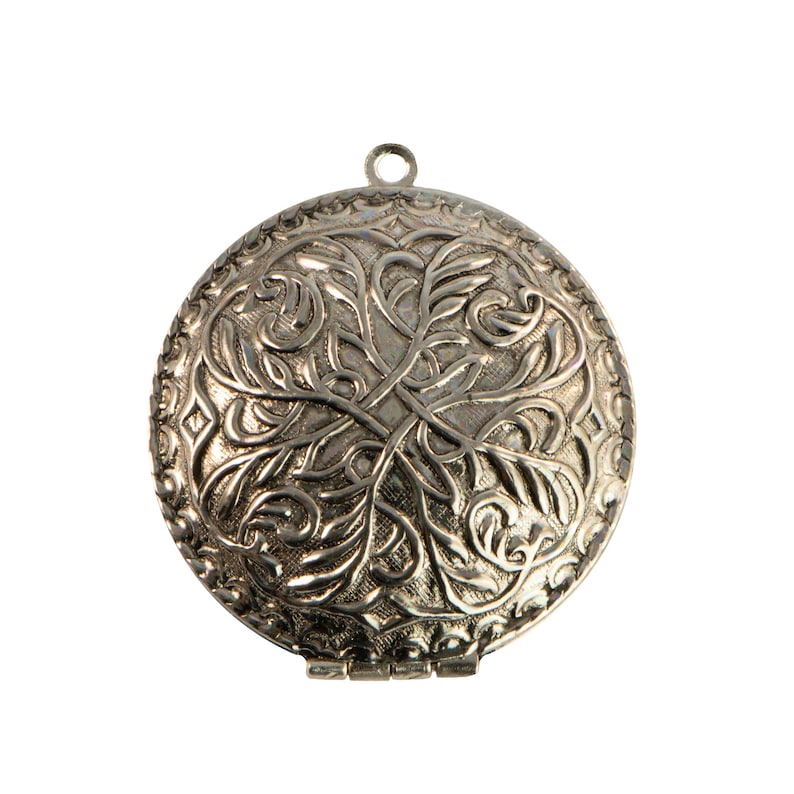 May include: A silver locket with an intricate floral design. The locket has a hinged opening and a loop for attaching a chain.