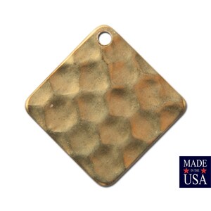 May include: A square-shaped, hammered brass pendant with a hole at the top for hanging. The pendant has a textured, hammered surface.