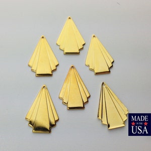May include: Six gold-colored metal art deco style pendants. Each pendant is shaped like a triangle with a series of overlapping lines.