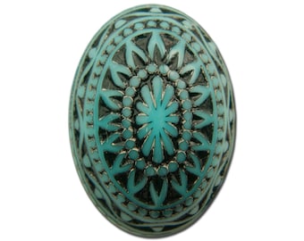 Puede incluir: Una cuenta redonda de color azul turquesa y negro con un diseño decorativo de mandala.