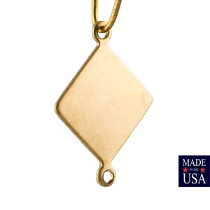 May include: A gold-toned diamond-shaped pendant with a loop at the top and a jump ring at the bottom.