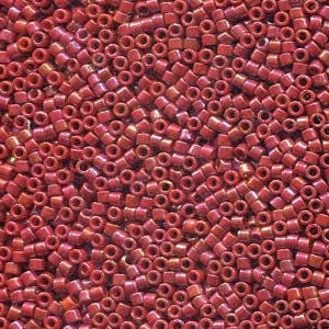May include: A large quantity of small, red, iridescent glass beads. The beads are round and have a slightly flattened shape. They are perfect for jewelry making or other craft projects.