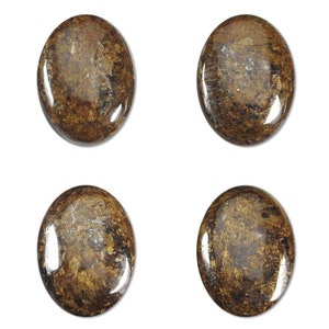 May include: Four oval-shaped, brown and gold gemstone cabochons with a marbled pattern.